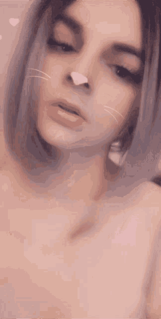 a close up of a woman with a cat nose on her face