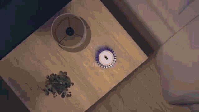 a purple circle is surrounding a white object on a table .
