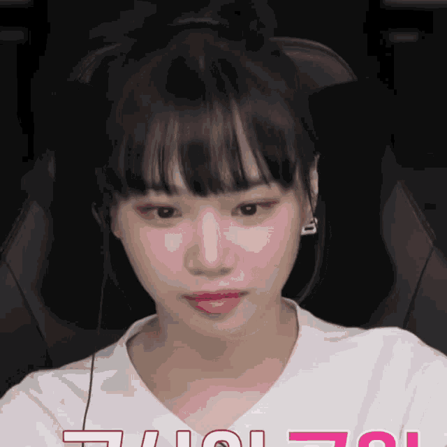 a woman wearing headphones and a white shirt with the letters i and o on it