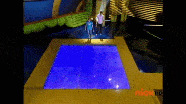 a screenshot of a nickelodeon show shows a man jumping into a pool