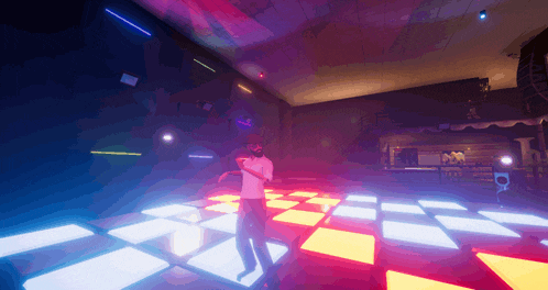 a man stands on a dance floor in a dark room with a microphone