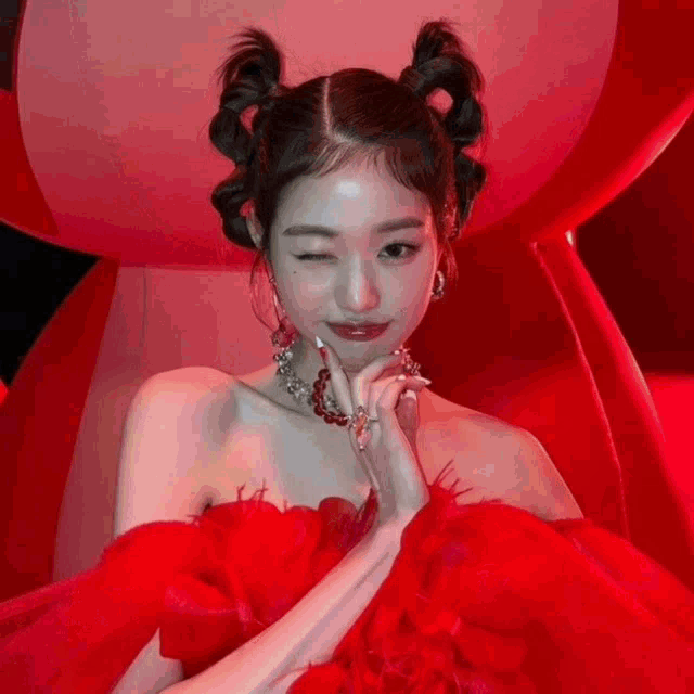 a woman in a red dress is making a funny face