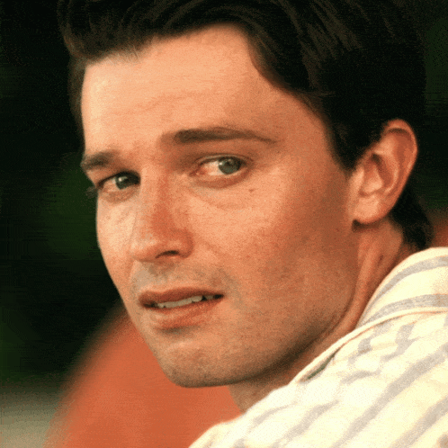 a close up of a man 's face with a smile on his face