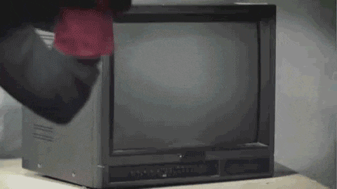 a person is cleaning a television with a cloth .