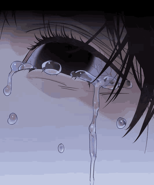 a close up of a person 's eye with tears coming out