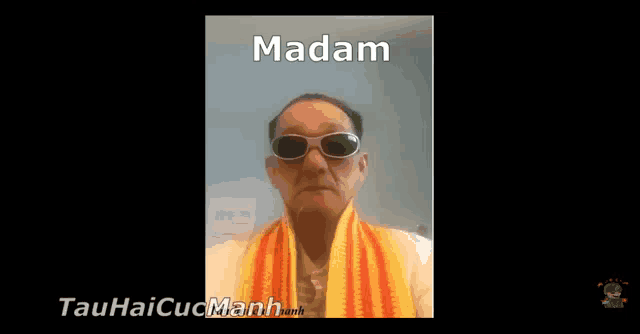 a man wearing sunglasses and a scarf with the word madam written on the bottom