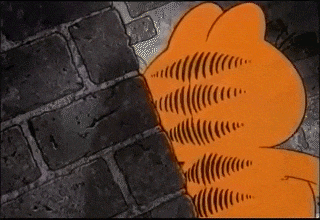 garfield is standing next to a brick wall and looking at something .