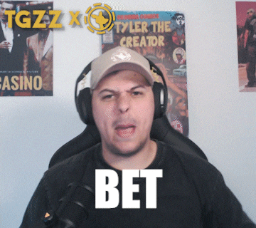 a man wearing headphones and a hat says bet in front of a poster for tyler the creator