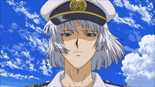 a man wearing a captain 's hat with the letter g on it is looking at the camera