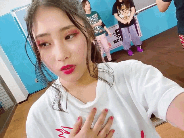 a girl taking a selfie with a sign in the background that says ' a ' on it