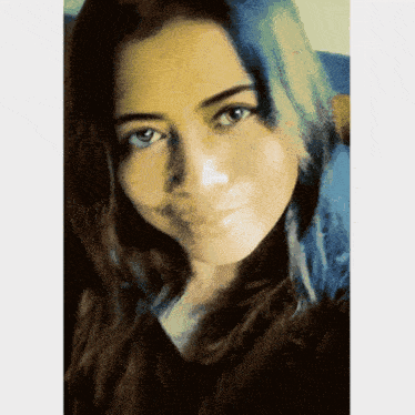 a close up of a woman 's face with a blurry background