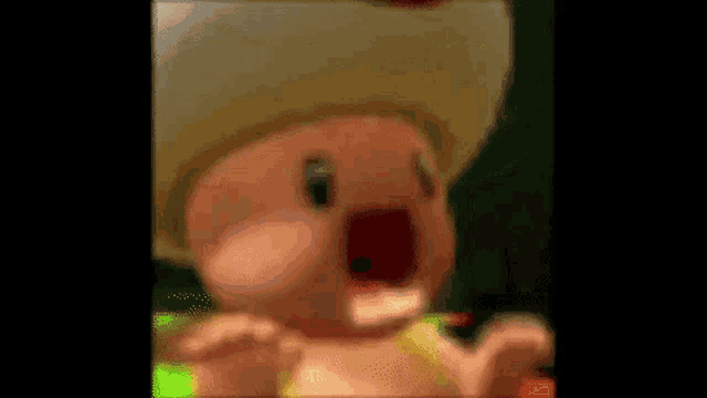 a close up of a cartoon character with a big mouth and a red nose .