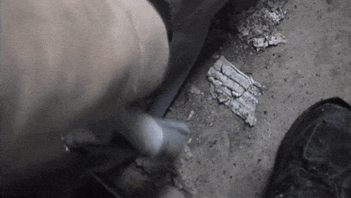 a person laying on the floor with a piece of paper on the ground