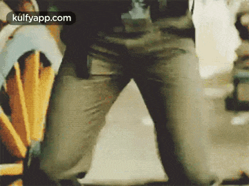 a close up of a person 's legs and pants in a blurry picture .