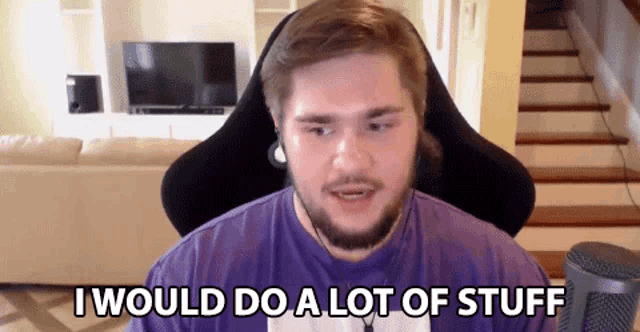 a man in a purple shirt is sitting in front of a microphone and saying i would do a lot of stuff