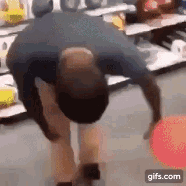 a man is doing a handstand in a store while looking at something .