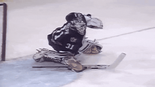a group of ice hockey players are laying on the ice .