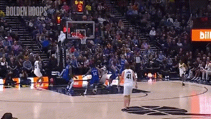 a basketball game is being played in front of a crowd and the scoreboard says golden hoops