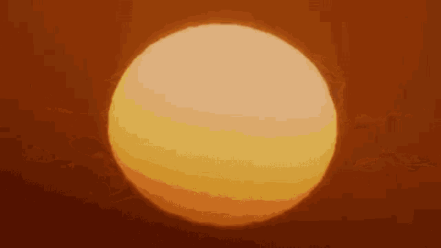 the sun is shining through the clouds in the sky at sunset .
