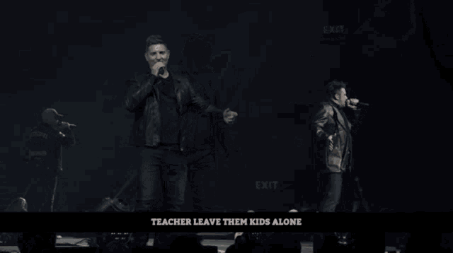 a man dancing on a stage with the words teacher leave them kids alone below him