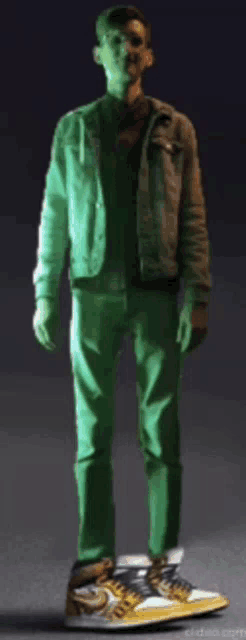 a man wearing green pants and a denim jacket is standing on a pair of nike shoes