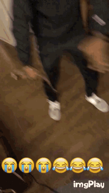 a person wearing a pair of adidas sweatpants is laughing
