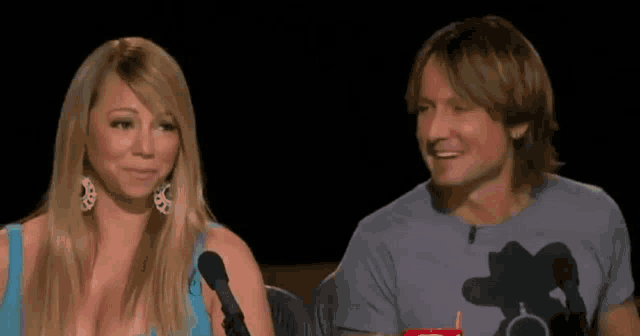 mariah and keith sit next to each other in front of a microphone