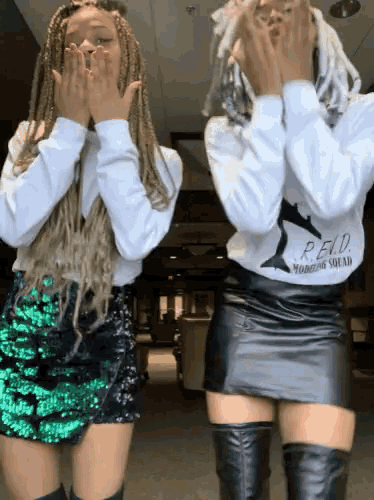 a woman wearing a white sweatshirt that says p.f.d. modeling squad on it