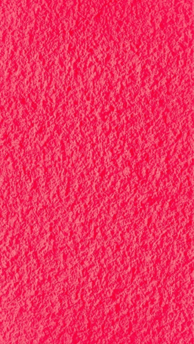 a close up of a bright pink background with a texture