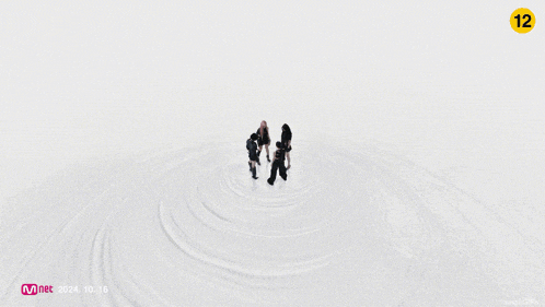 a group of women are standing in a circle with a pentagram on their backs