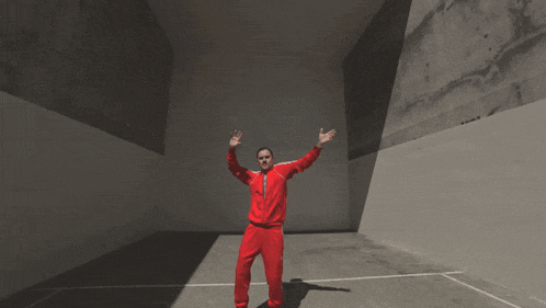 a man in a red adidas tracksuit is dancing