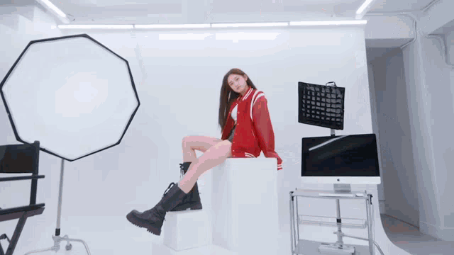 a girl in a red jacket with the letter l on the front