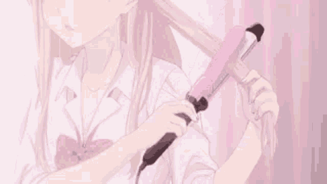 a girl is holding a curling iron in her hand .