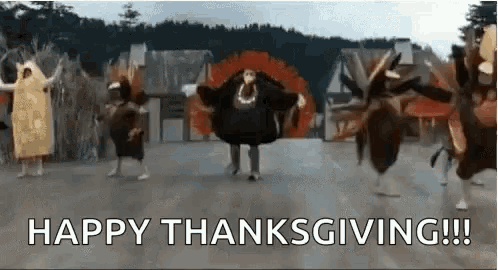 a group of people dressed as turkeys are dancing in front of a sign that says `` happy thanksgiving !!! ''