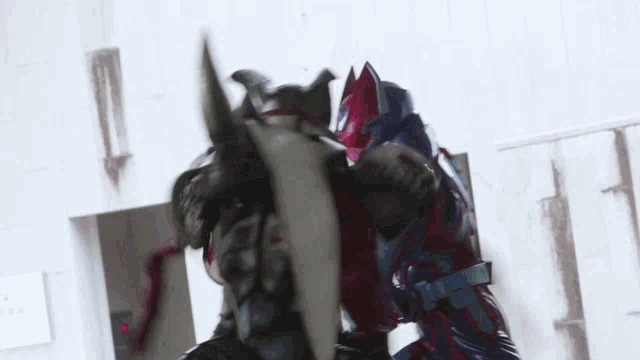 a man in a samurai armor is fighting another man in a samurai armor .