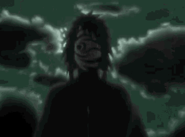 a full moon is shining through the clouds in a dark green sky .