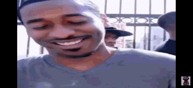 a close up of a man smiling with his eyes closed .
