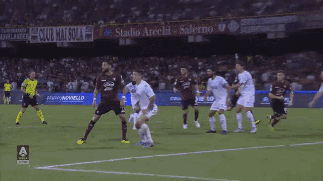a soccer game is being played in front of a sign that says " angri "