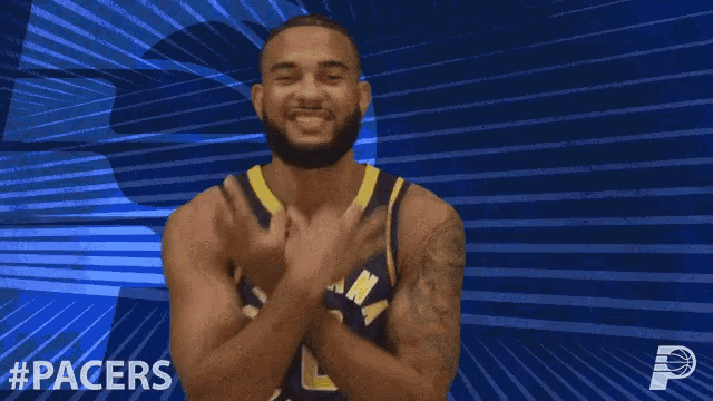 a man in a indiana pacers jersey is making a peace sign