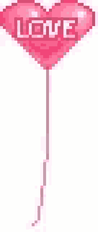 a pink heart shaped balloon with the word love on it is hanging from a string .