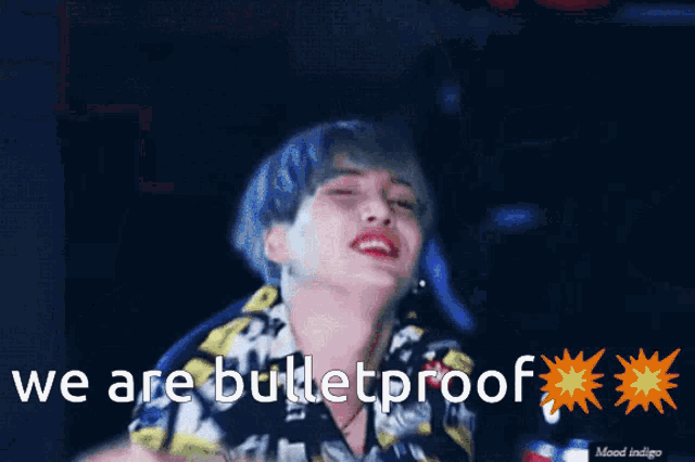 a man with blue hair says " we are bulletproof " in front of a blue background