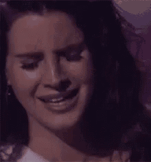 a close up of a woman crying with the words ewnt written above her face .