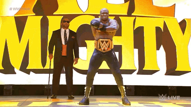 a man in a suit stands next to a man with a cane in front of the word mighty