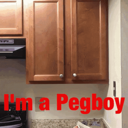 a kitchen with wooden cabinets and the words i 'm a pegboy in red
