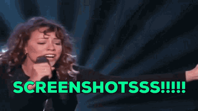 a woman singing into a microphone with the words screenshotss !!! written below her