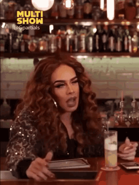 a woman sitting at a bar with the words multi show on the top