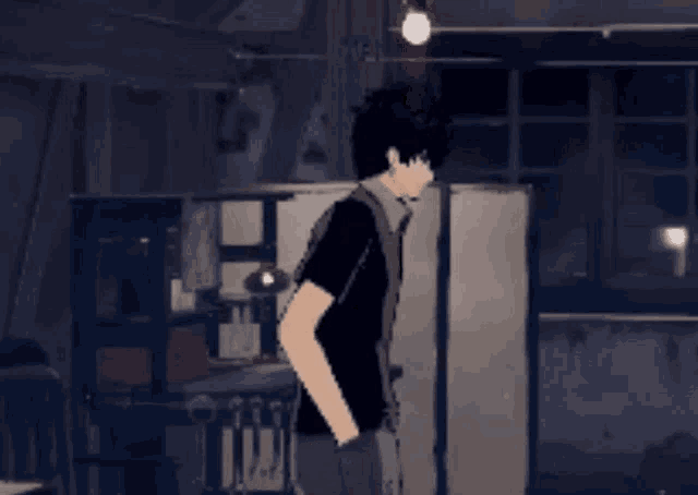 a man in a black shirt is standing in a room with his hands on his hips