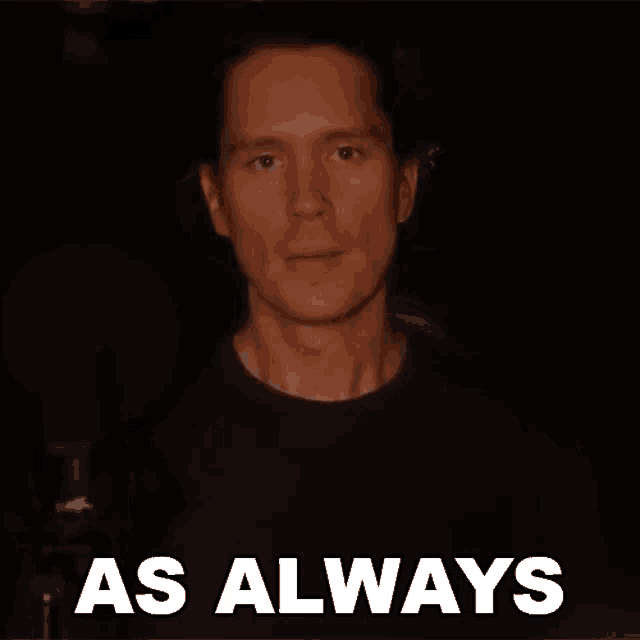 a man is standing in front of a microphone with the words as always behind him