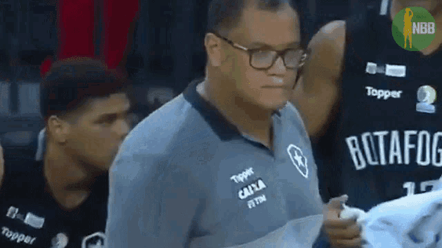 a man wearing glasses and a topper shirt