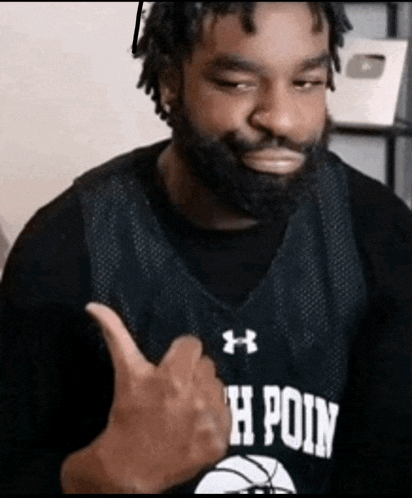 a man with a beard is wearing a basketball jersey that says h point